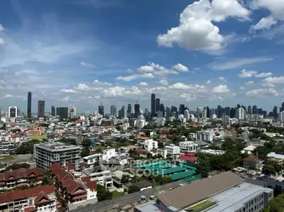 Stunning cityscape view showcasing urban skyline and residential areas under a clear blue sky.