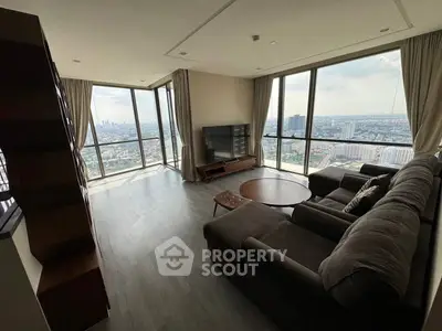 Spacious living room with panoramic city views and modern furnishings