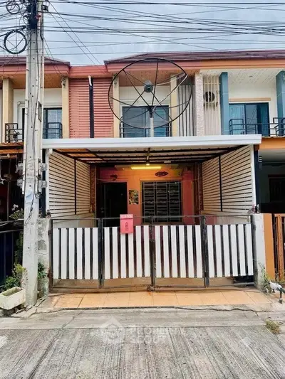 Charming townhouse with unique satellite dish feature and gated entrance