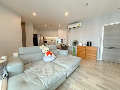 Spacious modern living room with open kitchen and cozy seating area