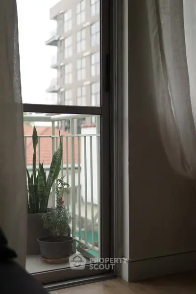 Cozy balcony view with potted plants and cityscape backdrop
