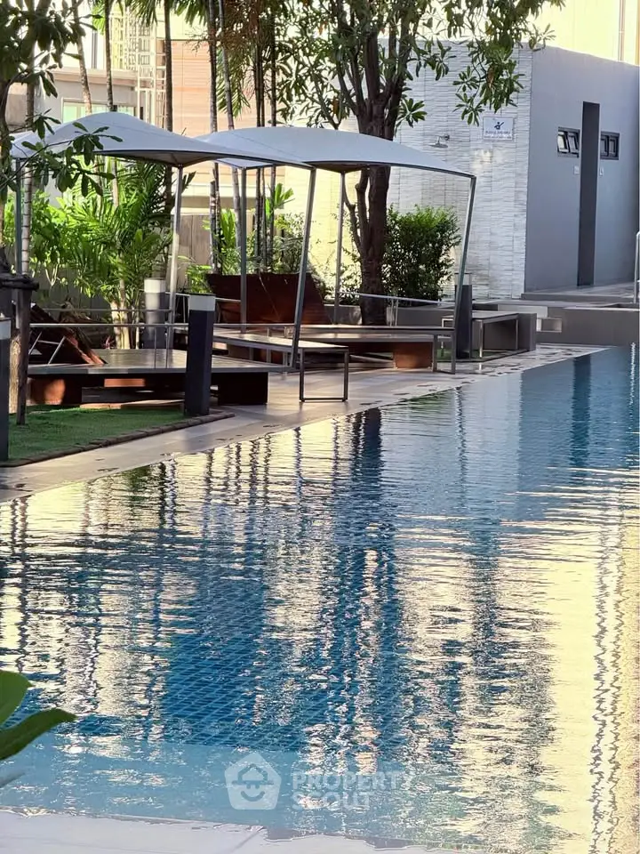 Luxurious poolside area with modern cabanas and lush greenery, perfect for relaxation and leisure.