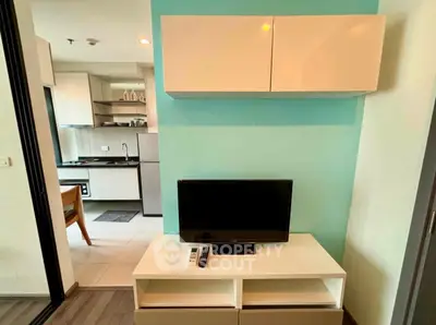 Modern living room with TV and kitchen view in stylish apartment