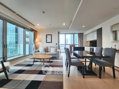 Spacious modern living room with open kitchen and city view balcony in luxury apartment.
