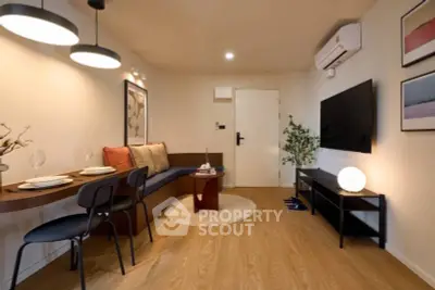 Stylish modern living room with cozy seating and wall-mounted TV