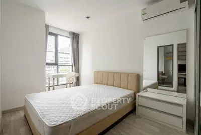 Modern bedroom with large window and air conditioning in urban apartment