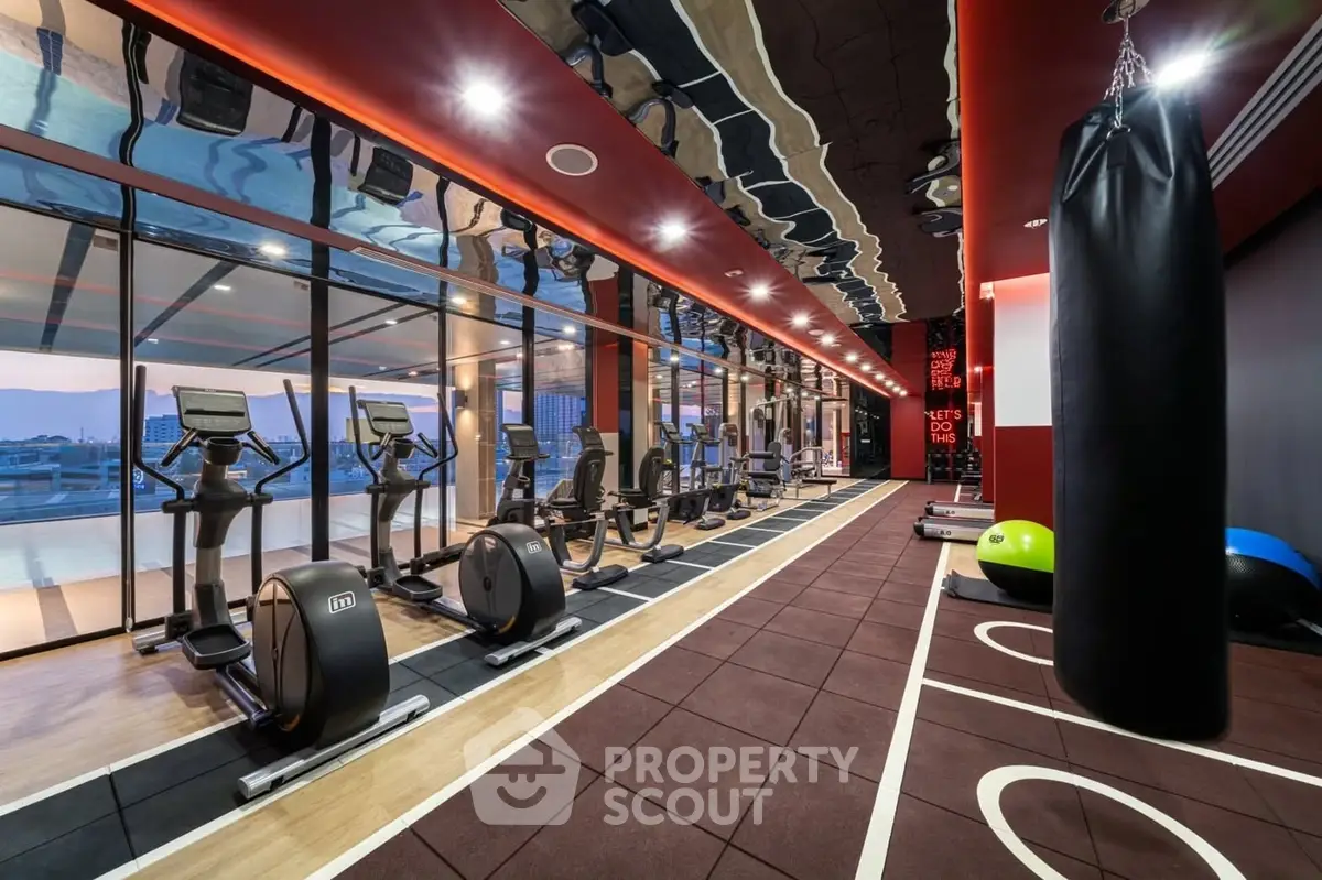 Luxurious modern gym with panoramic city views and state-of-the-art equipment in a high-end residential building.