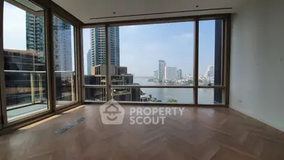 Spacious modern living room with stunning river view and floor-to-ceiling windows in luxury apartment.