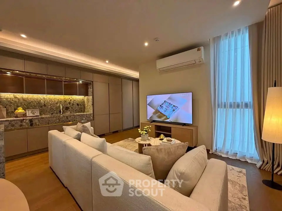 Luxurious modern living room with elegant decor and large TV, perfect for relaxation and entertainment.