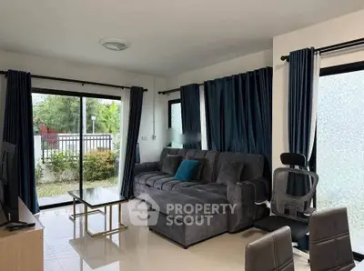 Spacious living room with modern furniture and garden view, perfect for relaxation.
