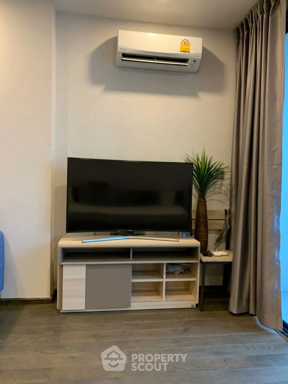 Modern living room with sleek TV setup and air conditioning