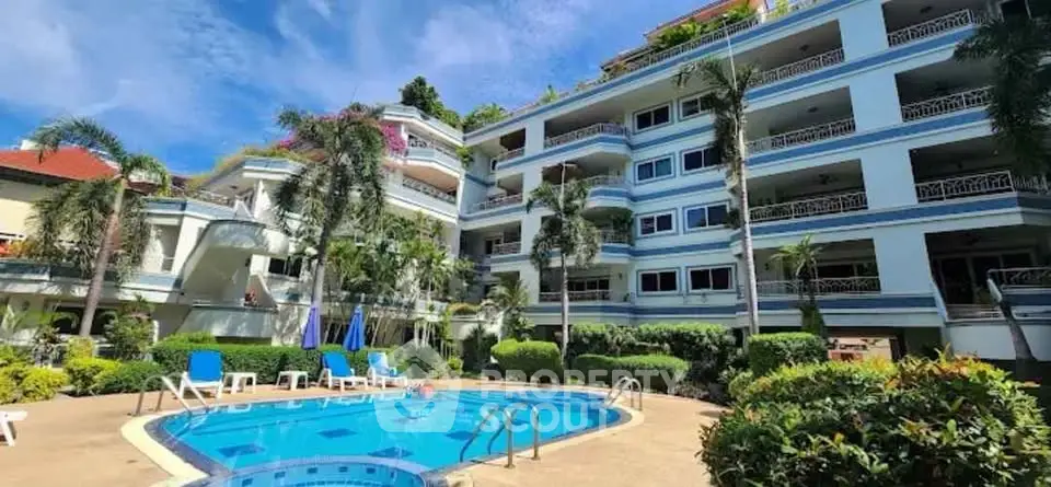 Luxurious apartment complex with pool and lush landscaping, perfect for resort-style living.