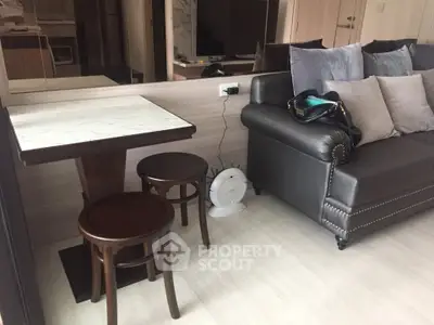 Cozy living room with stylish sofa and dining area in modern apartment