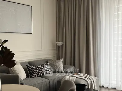 Elegant living room with modern decor and large window drapes