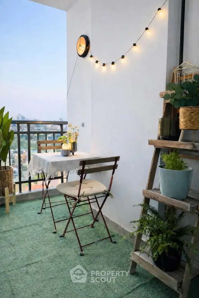 Charming balcony with cozy seating and city view, perfect for relaxation.