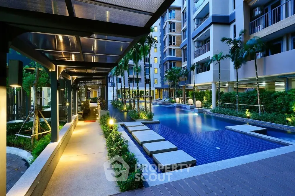 Luxurious condominium with illuminated pool and modern architecture