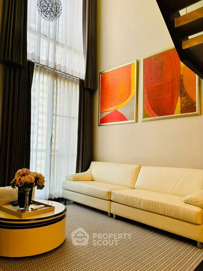 Luxurious living room with high ceilings and modern art decor