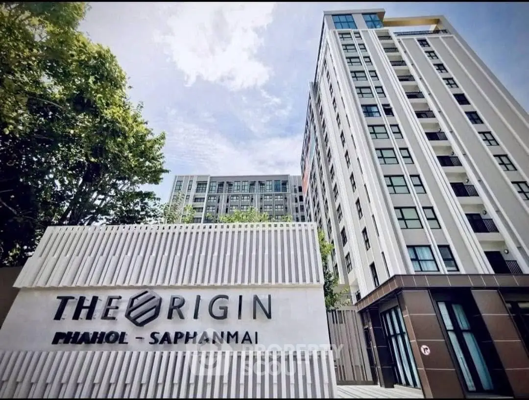Modern high-rise building with sleek design at The Origin Pahol Saphanmai.