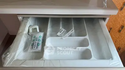 Modern kitchen drawer with organized compartments and sleek design.