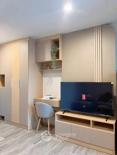 Modern living room with built-in storage and TV unit, featuring a cozy study nook.