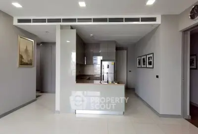 Modern kitchen with sleek cabinetry and stainless steel appliances in a stylish apartment.