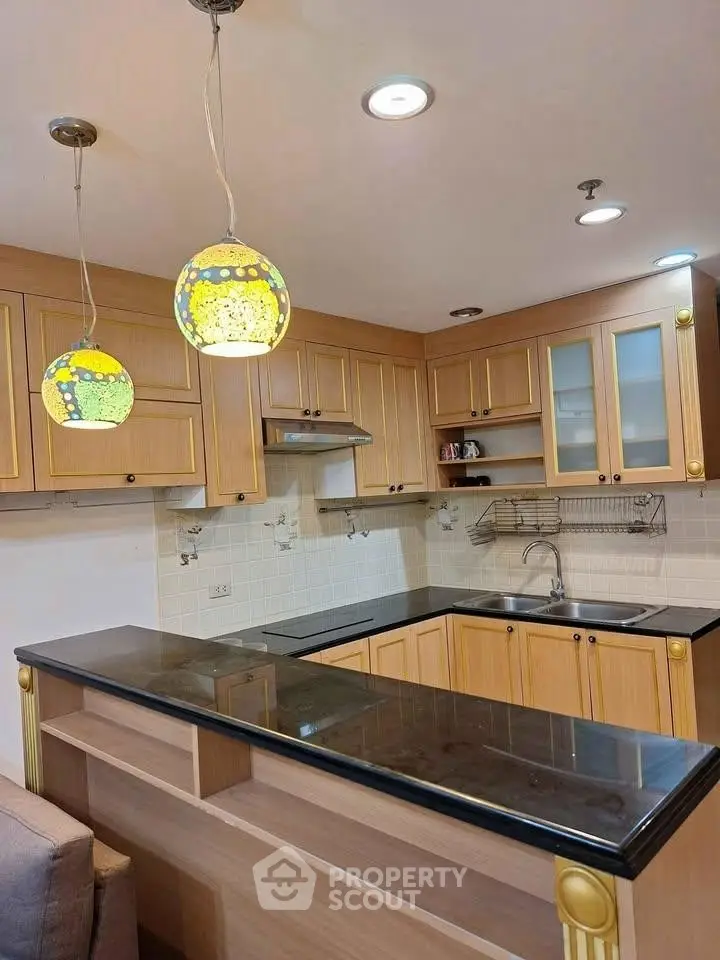 Charming kitchen with elegant wooden cabinets and stylish pendant lighting