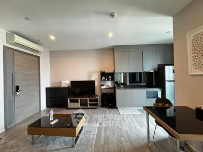 Modern living room with sleek furniture and open kitchen layout