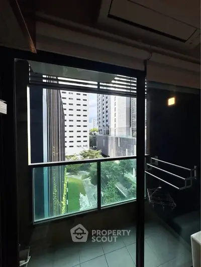 Modern apartment balcony with city view and sleek glass railing