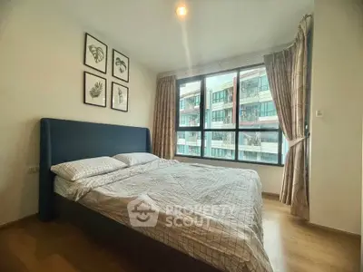 Cozy bedroom with large window and modern decor in urban apartment