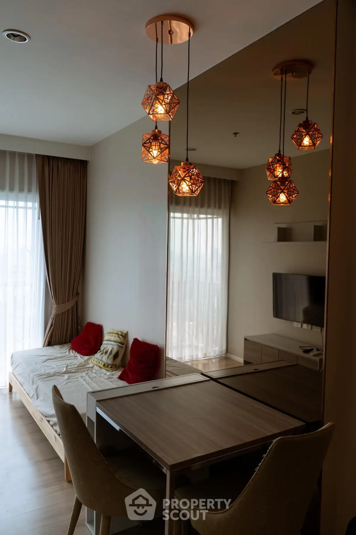 Modern living room with stylish lighting and cozy seating area in a contemporary apartment.