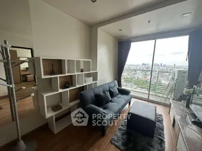 Modern living room with city view, stylish furniture, and floor-to-ceiling windows in a high-rise apartment.