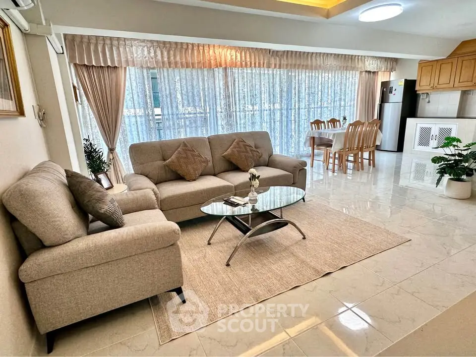 Spacious open-plan living room with elegant decor and dining area