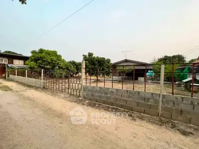 Spacious rural property with fenced yard and outbuilding, ideal for development or agriculture.