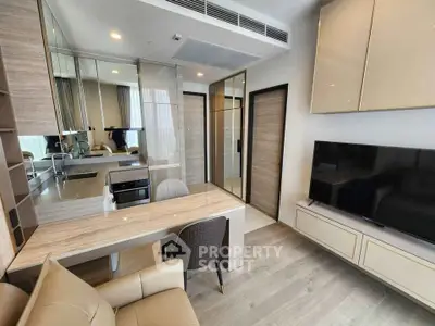 Modern living room with sleek furniture and integrated kitchen appliances