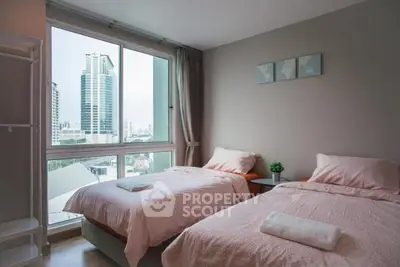 Modern bedroom with twin beds and city view from large window