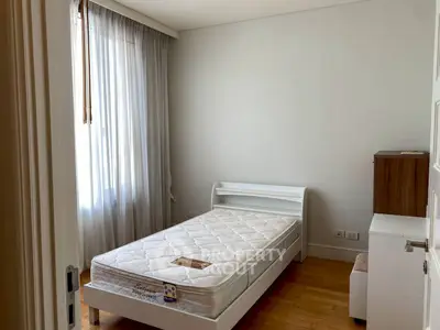 Cozy bedroom with natural light and minimalist furniture, perfect for a serene living experience.