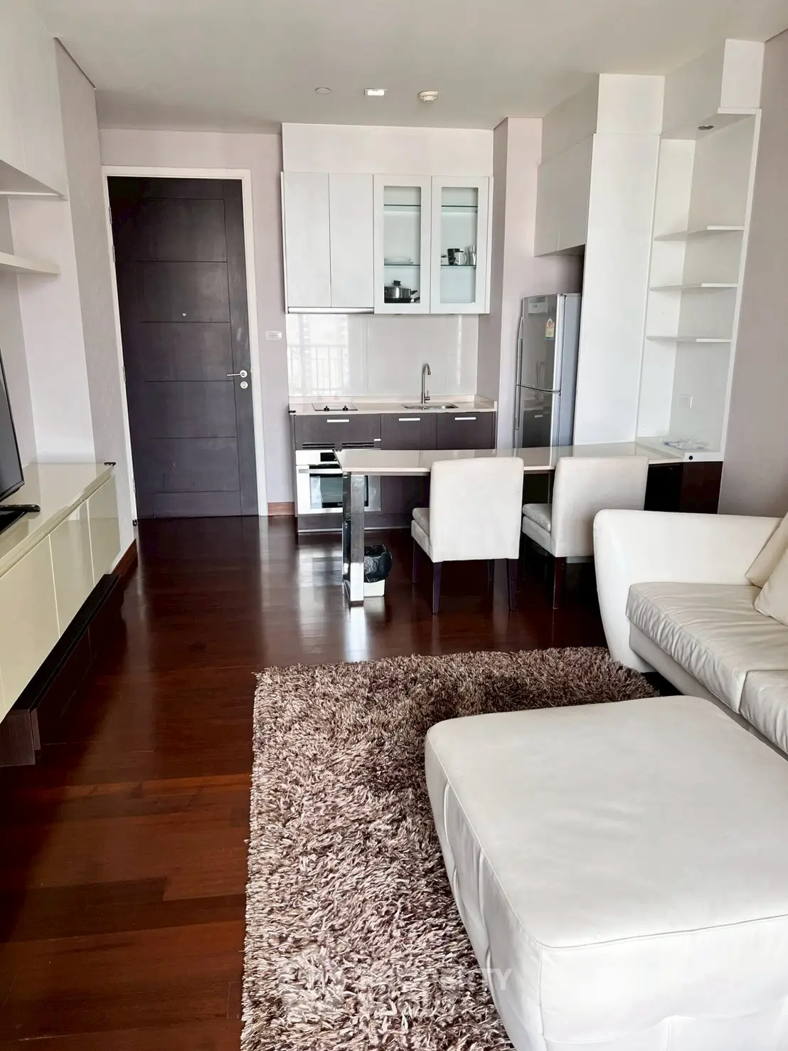 Modern living room with open kitchen and stylish furniture in a cozy apartment.