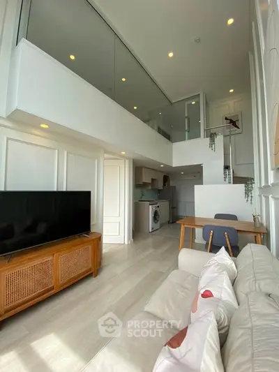 Modern duplex living room with high ceilings and stylish decor