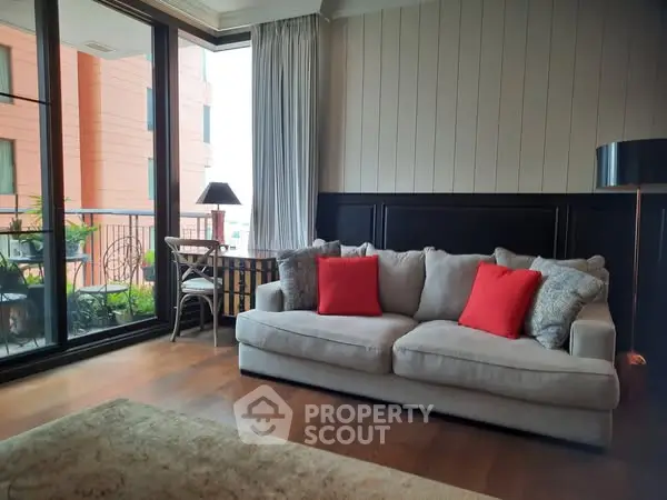 Cozy living room with plush sofa and balcony view in modern apartment