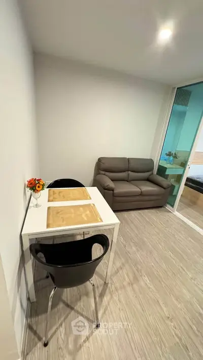 Cozy living room with modern decor and compact dining area