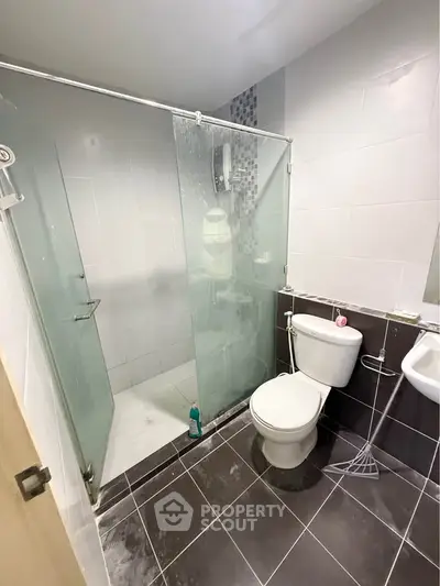 Modern bathroom with glass shower enclosure and sleek tile design