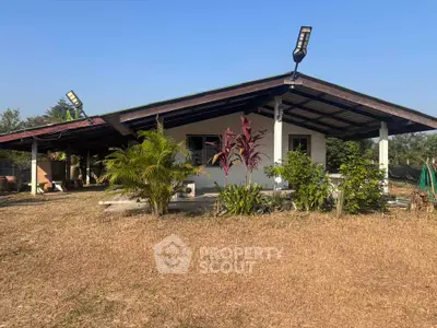 Charming rural house with spacious yard and lush greenery, perfect for serene living.