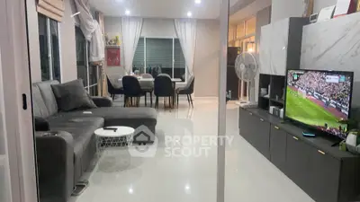 Spacious modern living room with sleek furniture and large windows for natural light.