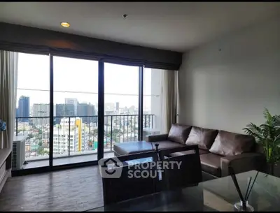 Modern living room with stunning city view and large balcony access.