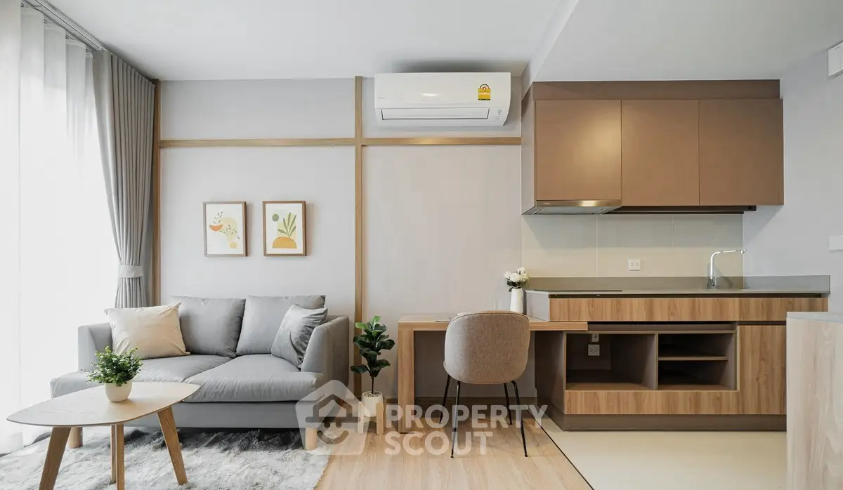 Modern living room with cozy sofa and compact kitchen in open layout