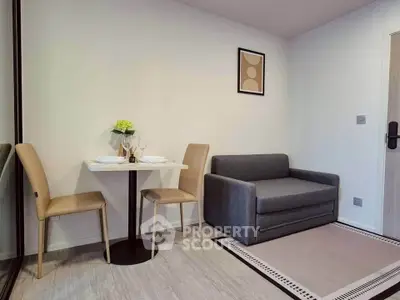 Modern living room with cozy sofa and dining area in stylish apartment.