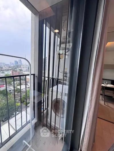 Modern apartment balcony with washing machine and city view