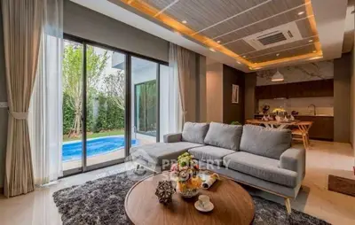 Luxurious living room with pool view and modern open kitchen design