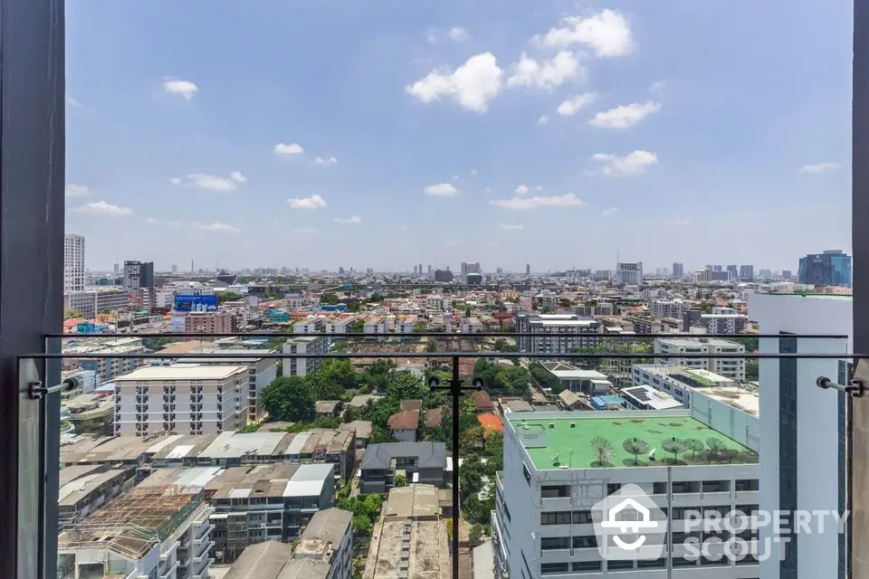 Stunning cityscape view from high-rise balcony with clear blue sky