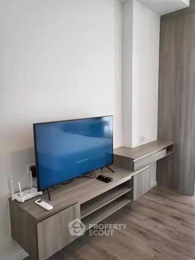 Modern living room with sleek TV stand and wooden flooring